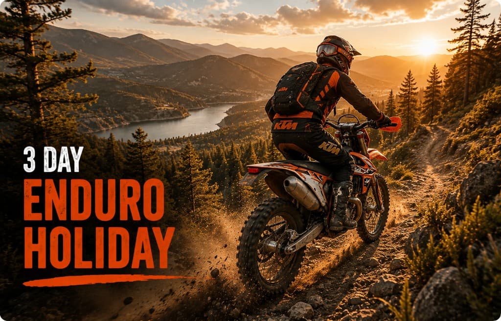 Enduro rider on a rocky mountain trail overlooking a valley at sunset